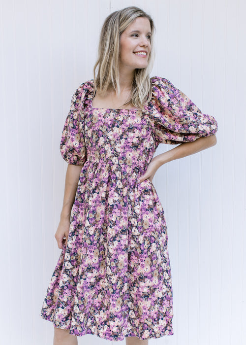 Model wearing a floral corduroy dress with a square neckline, smocked back and bubble short sleeves.