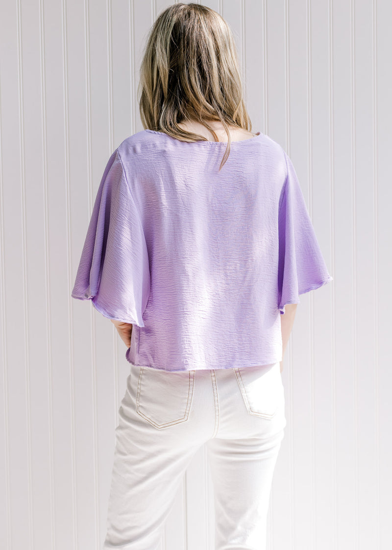 Back view of a light lavender slightly cropped top with flutter short sleeves. 