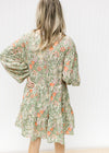 Back view of cream dress with olive, coral and gold floral, smocked back and bubble long sleeves. 
