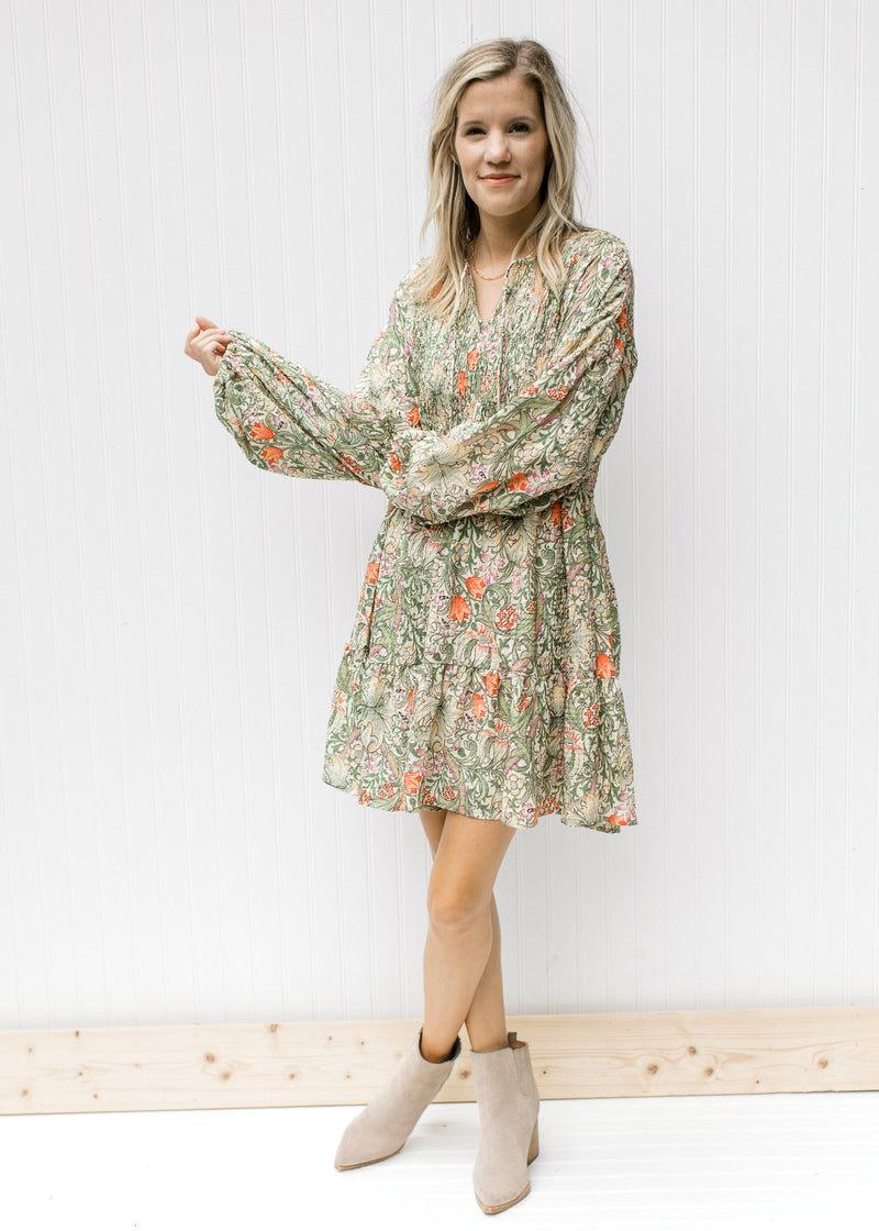 Model wearing booties with a cream dress with a floral pattern, smocked back and bubble long sleeve.