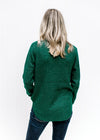 Back view of Model wearing a forest green sweater with a textured material and long sleeves. 