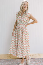 Model wearing wedges with a cream midi with pink peonies, smocked waist and a full front zip.