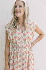 Close up of full front zip and smocked waist on a cream dress with pink peony flowers.