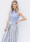 Model wearing a ribbed gray sleeveless body suit with a mocked neckline and a 2 snap closure. 