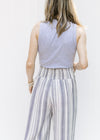 Back view of Model wearing a ribbed gray sleeveless body suit with a mocked neckline. 