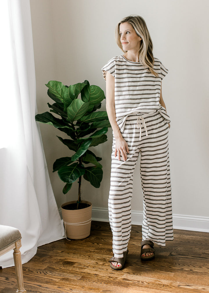 Model wearing gray and white striped set with a short sleeve top and wide leg bottoms.