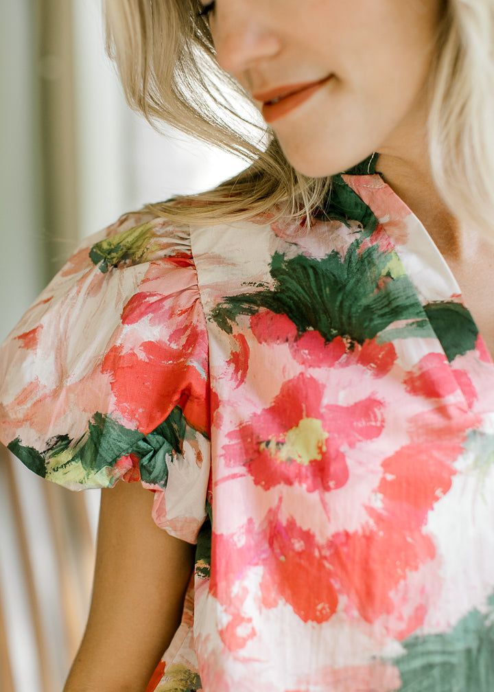 Close up of bubble short sleeve with pleated shoulder on a watercolor blouse. 