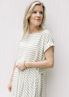 Close up of capped sleeves and boatneck on a cropped green and white striped top with a skirt.