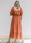 Back view of smocked band and square neck on a rust midi dress with bubble short sleeves. 