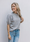 Model wearing a heather gray sweater with bubble short sleeves, pleated shoulders and round neck.