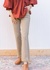 Model wearing high rise straight leg khakis with side hem detail and cropped cut. 