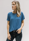 Model wearing jeans with a blue short sleeve tee with a cropped fit and bamboo material. 
