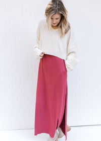 Model wearing a maxi and booties with a ribbed ivory sweater with a cropped fit and long sleeves.