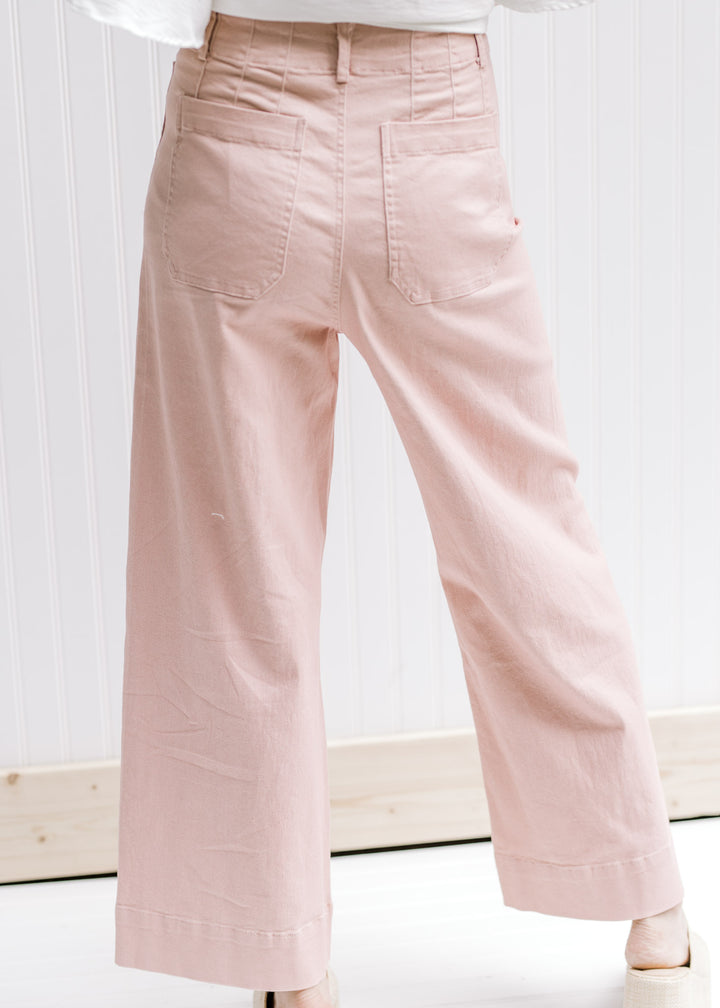 Back view of model wearing wide leg, cropped blush color bottoms with patch pockets. 