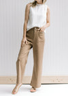 Model wearing taupe wide leg pants with hi-waisted with patch pockets.