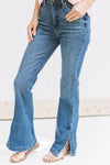Model wearing a medium wash, hi waisted jean with a split hem and tummy control. 