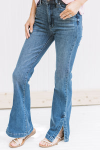 Model wearing a medium wash, hi waisted jean with a split hem and tummy control. 