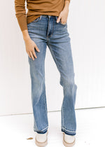 Model wearing medium wash,Judy Blue jeans with a release hem, control top and a boot cut. 