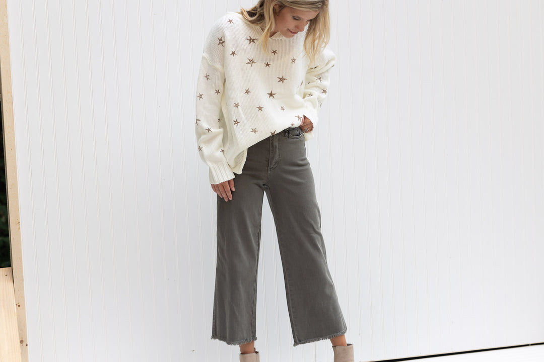Model wearing sage crop pants with a frayed hemline and tummy control. 