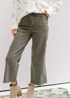 Model wearing booties with sage crop pants with a frayed hemline and tummy control. 