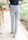 Back view of Model wearing light wash bootcut jeans with tummy control and a high waisted fit.