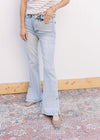 Model wearing lightwash bootcut jeans with side slits and a built in tummy control. 