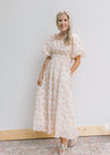 Model wearing wedges with a cream dress with peach flowers, bubble short sleeves and smocked waist.