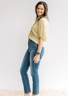 Model wearing jeans with a lemon grass lightweight top with patch pockets and 3/4 bubble sleeves.