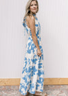 Side view of model wearing a white maxi with light blue floral and racer back with back tie.