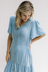 Model waring a v-neck chambray midi with smocked side detail and flutter short sleeves.