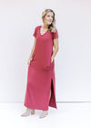 Model wearing a soft maroon colored v-neck maxi with short sleeves, split side hem and booties. 