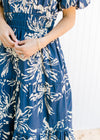 Close up of smocked waist on a blue maxi with tiers and short puff sleeves. 