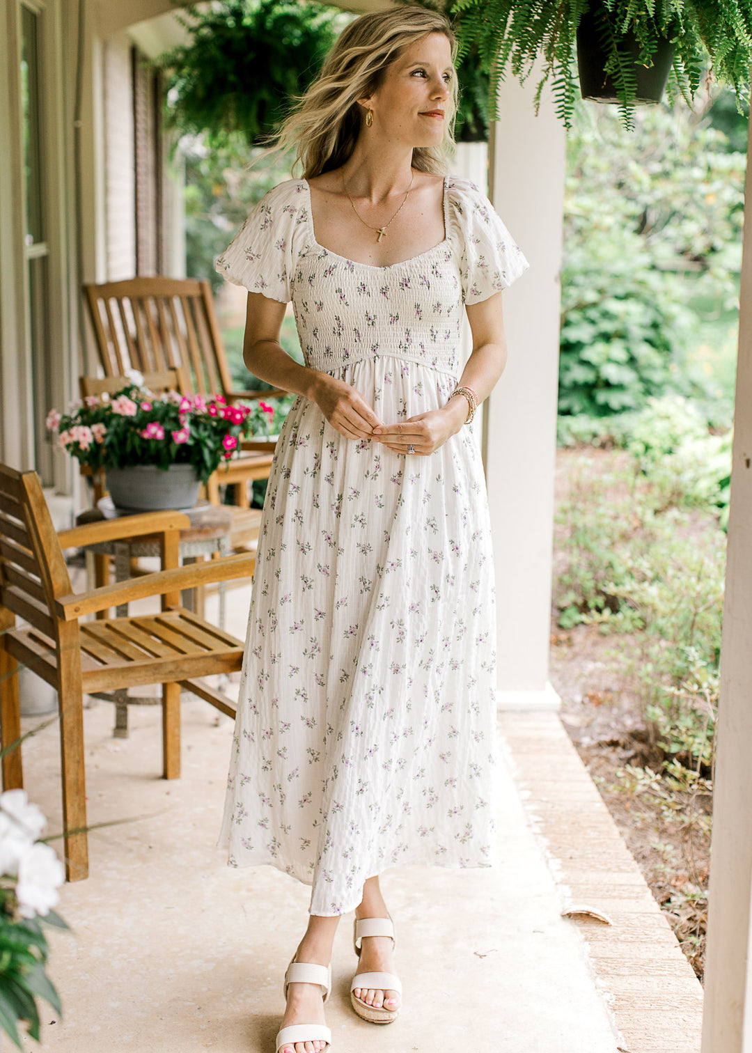 Model wearing a cream maxi with lavender floral, a smocked bodice and bubble short sleeves.