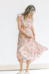 Model twirling in a mint dress with a floral pattern, ruffle capped sleeves and a pleated skirt. 