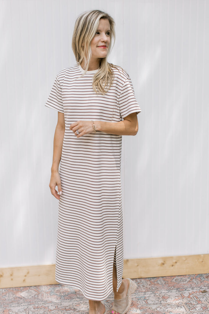 Model wearing a white midi with mocha stripes, short sleeves and a round neck.