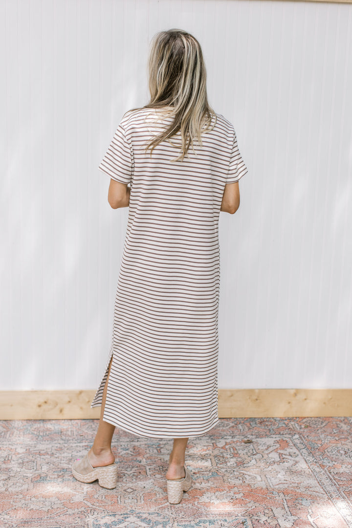 Back view of Model wearing a white midi with mocha stripes, short sleeves and a round neck.