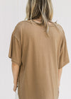 Back view of Model wearing a mocha colored tee with short sleeves, exposed hem and split sides.