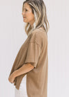 Side view of split sides and high low cut on a model wearing a mocha colored tee.