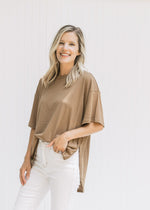 Model wearing a mocha colored tee with short sleeves, exposed hem and split sides.