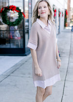 Model wearing a short sleeve faux shirtwaist in taupe and white stripe with a taupe sweater overlay.