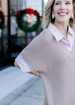 Close up of taupe dress with a faux shirtwaist in taupe and white stripe with a collar. 