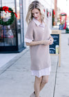 Model wearing a faux v-neck shirtwaist in taupe and white stripe with a taupe sweater overlay.