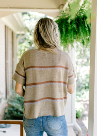Back view of taupe woven top with short sleeves and brown and gray stripes. 