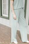 Close up of wide leg bottoms with elastic waist, pockets and a matching short sleeve top.