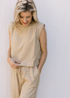 Close up of sleeveless top and wide leg bottoms with contrasting pockets on a yellow pants set.