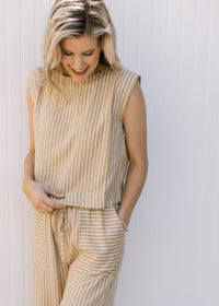 Close up of sleeveless top and wide leg bottoms with contrasting pockets on a yellow pants set.