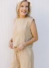 Close up of slightly cropped top on a cream and yellow striped pants set with wide legs. 