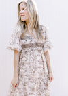 Model wearing a cream dress with brown floral, bubble short sleeves and a smocked bust. 