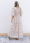 Back view of a cream short sleeve dress with brown floral, square neck and smocked bodice. 