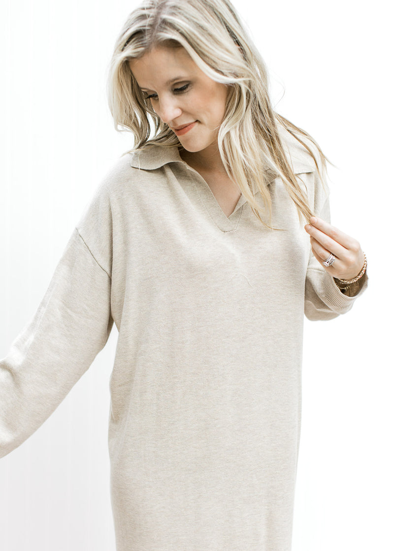 Close up of v-neck and exaggerated collard on a long sleeve wheat colored dress. 